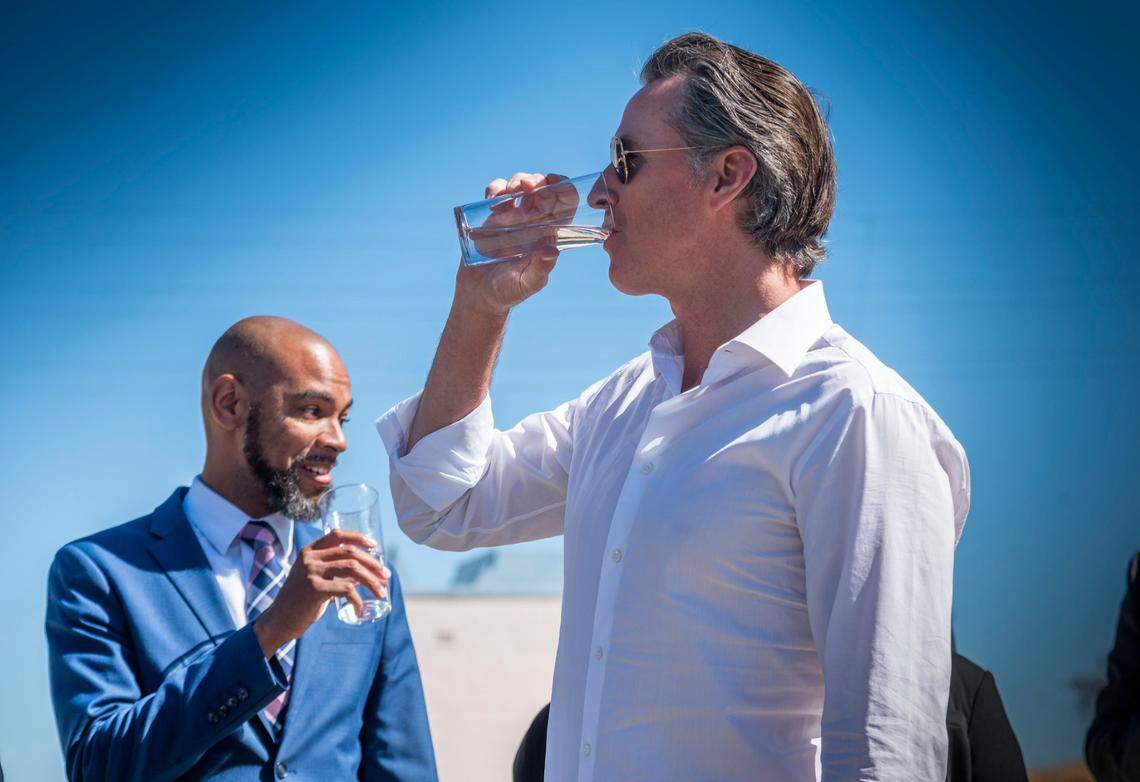 Gov. Gavin Newsom drinks water from the Antioch Water Treatment Plant with Antioch Mayor Lamar Thorpe on Thursday. The water was a sample of the future output of the Brackish Water Desalination Project, the first desalination project to be built in the Delta, currently under construction at the city’s water treatment plant.