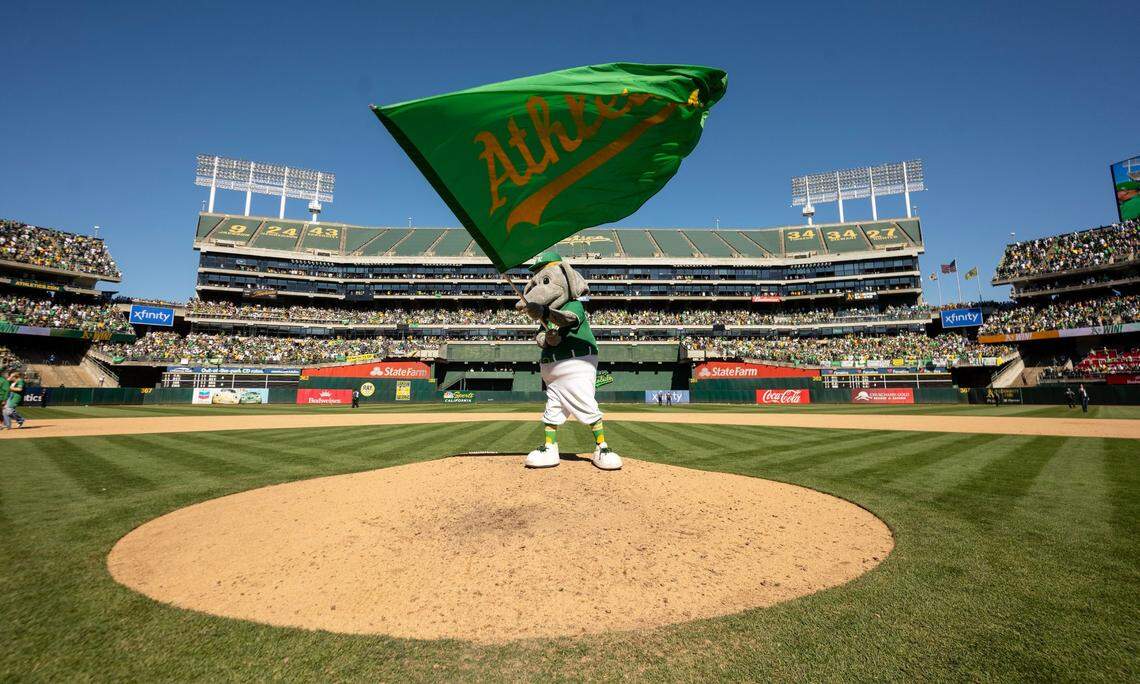 Oakland Athletics mascot Stomper waves the team flag following the A’s final game in Oakland on Thursday.