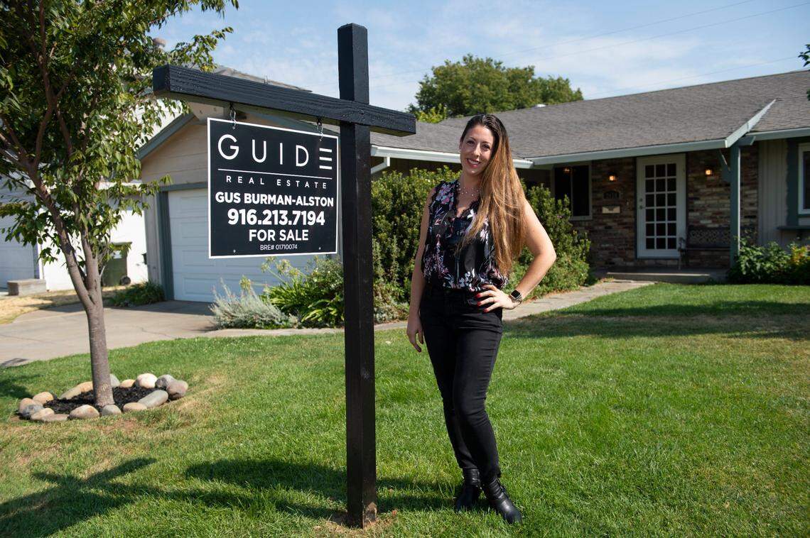 Leanna Halldorf, a real estate agent with Guide Real Estate, stands in front of a home listed by a colleague for $425,000 in Arden Arcade’s Park Hills Estates neighborhood July 28. Halldorf said the majority of her clients are millennials, single people and first-time home buyers.