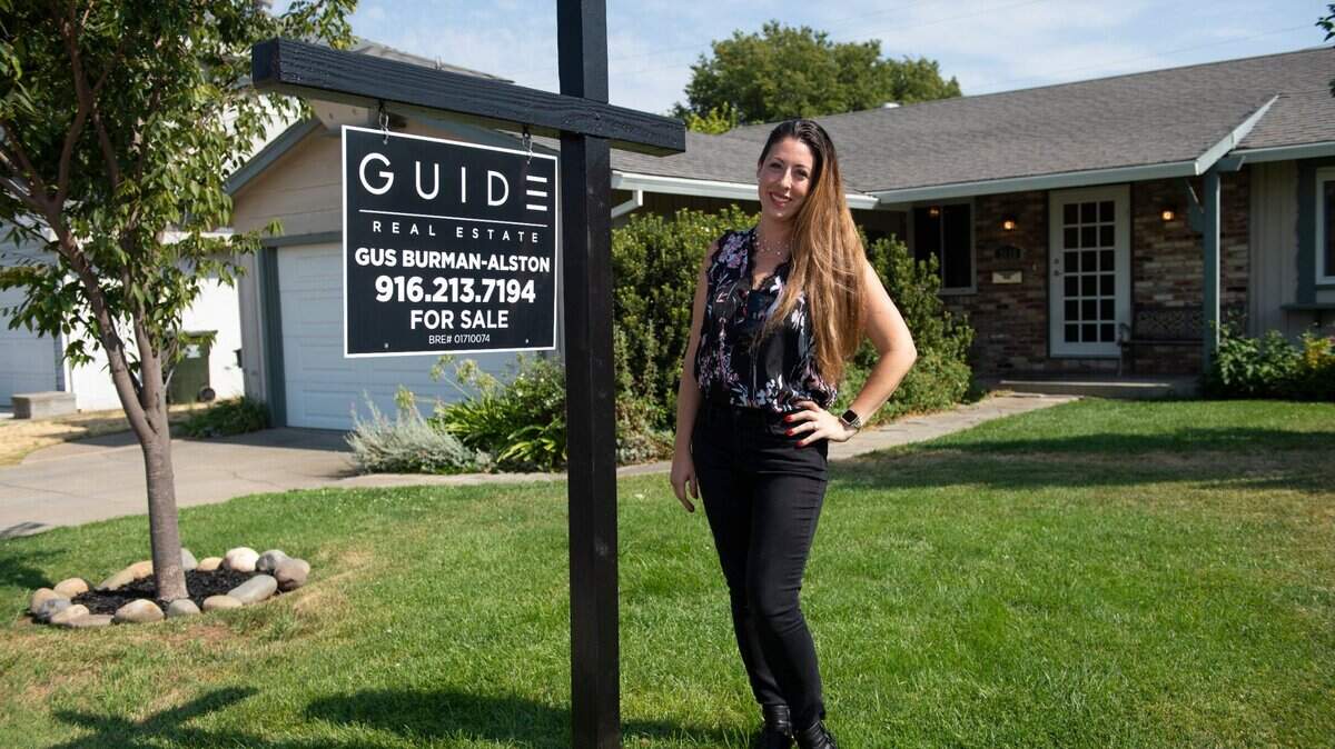 Leanna Halldorf, a real estate agent with Guide Real Estate, stands in front of a home in Sacramento’s Brentwood neighborhood, Wednesday, July 28, 2021, that is listed $425,000, by another agent in her office. Halldorf said the majority of her clients are millennials, single people and first-time home buyers.