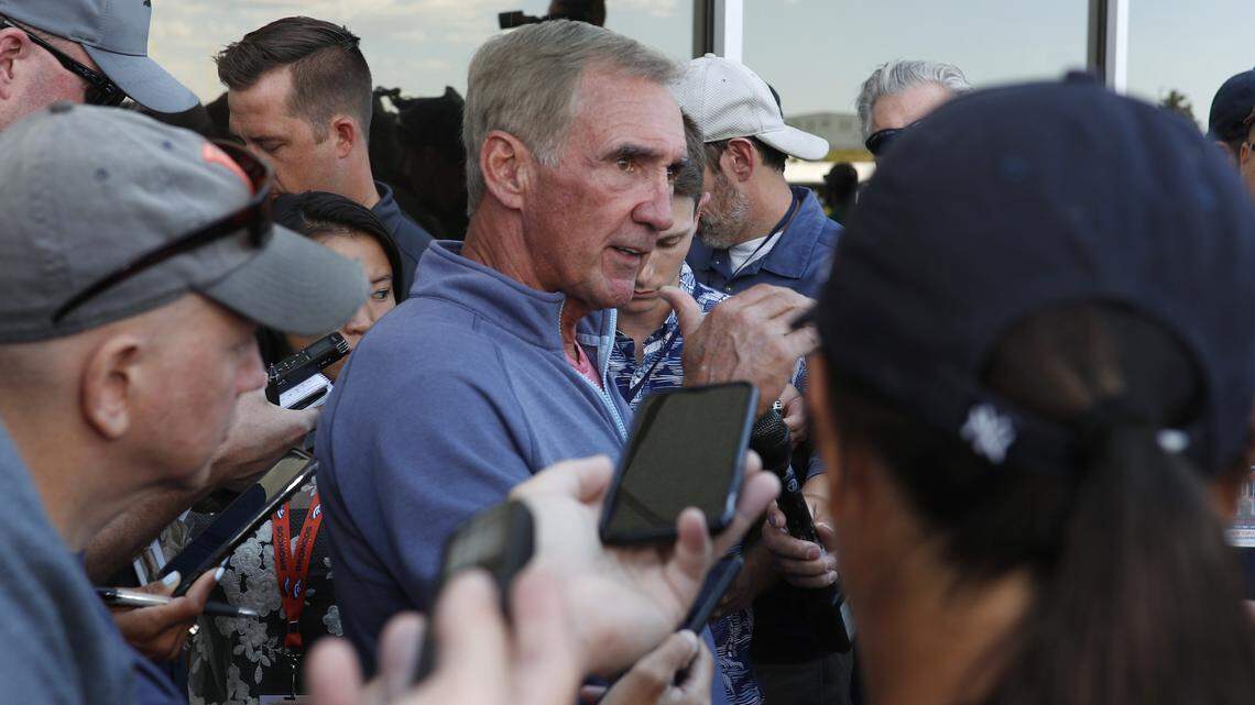 Retired NFL head coach Mike Shanahan, center, talks to reporters during a combined practice between the 49ers and Denver Broncos on Saturday in Englewood, Colo.