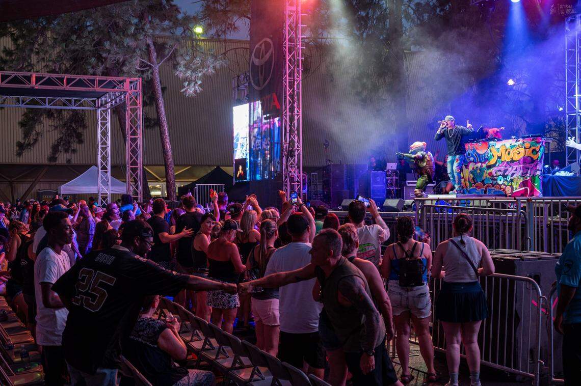 Concert attendees fist bump at the Vanilla Ice concert on the Golden 1 Stage during the California State Fair at Cal Expo on Friday, July 12, 2024, in Sacramento.