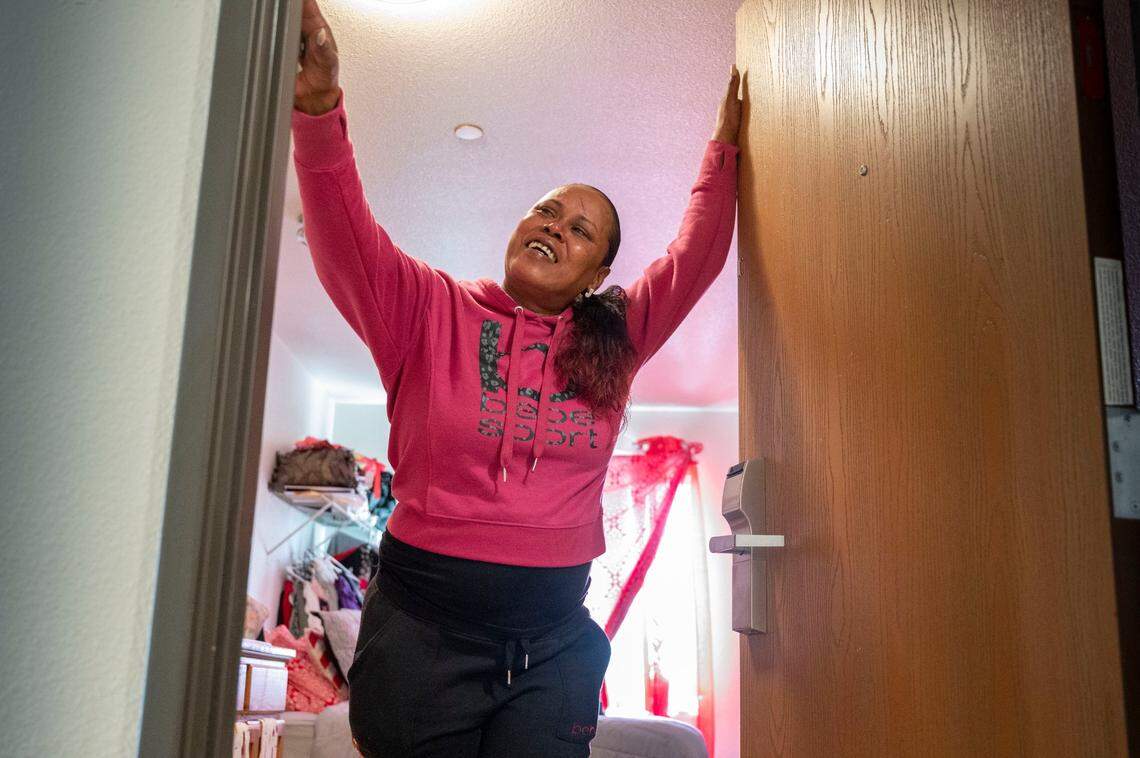 Formerly unhoused Sacramento resident Veada Pinkney, 49, beams with pride on Thursday, as she shows her home at La Mancha Way Apartments, which opened last year as the city’s first Homekey project. “I want to be a productive citizen of society and you guys gave me that opportunity,” said Pinkey, who is working at a local gas station. She thanked Mayor Darrell Steinberg, the Sacramento Housing and Redevelopment Agency and Mercy Housing, which converted a hotel in to 100 units of permanent supportive housing for people who had been homeless.