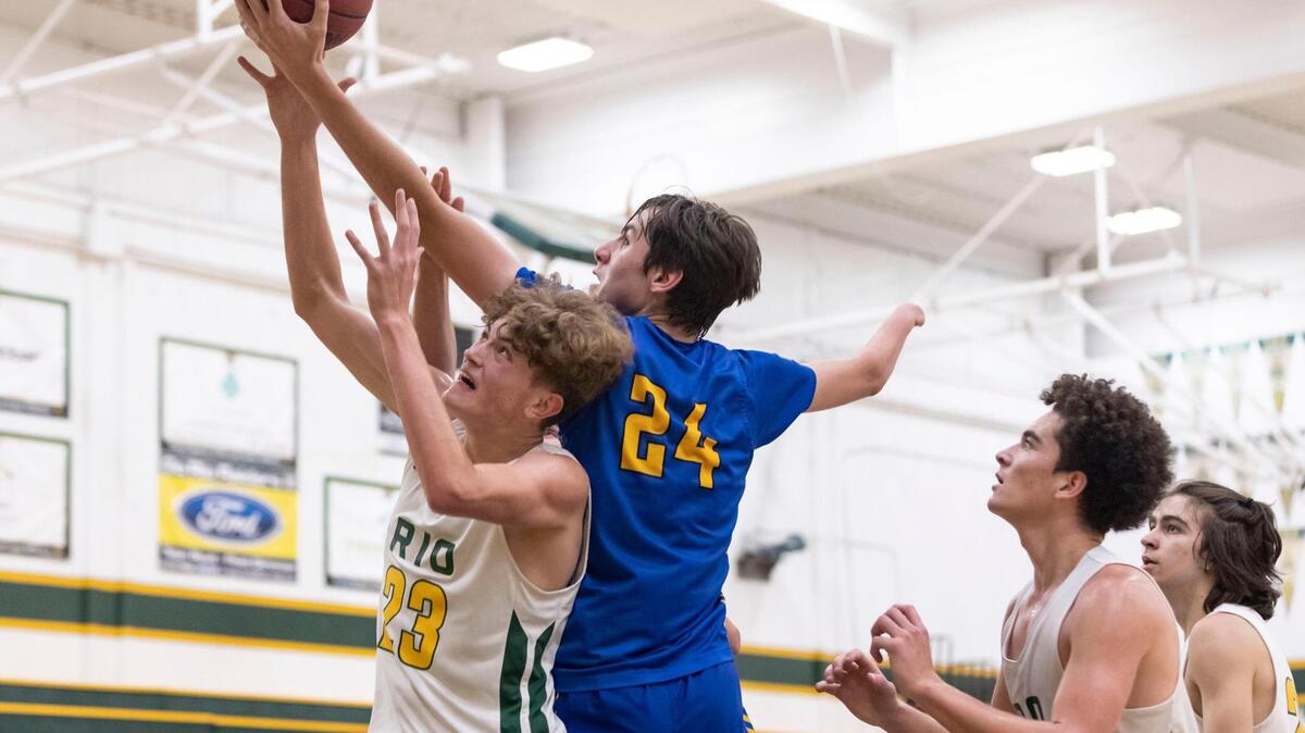 Del Campo center Damjan Agovic (24), who was born without a right hand, grabs a rebound over Rio Americano’s Shekhar Rana (23) in the third quarter during the game at Rio Americano High in Arden Arcade on Friday, June 4, 2021. Agovic is the team’s leading scorer and rebounder.