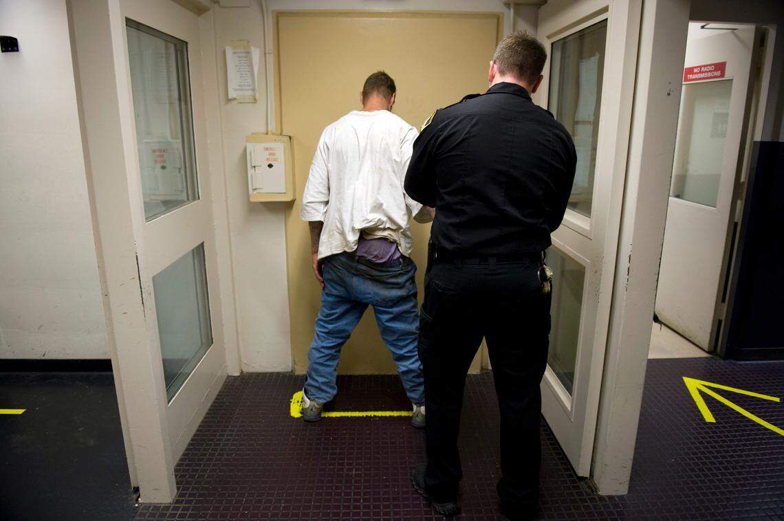 Sacramento County Sheriff’s Deputy Joe Reeve searches an arrested man before processing him into the Sacramento County Main Jail in 2009.