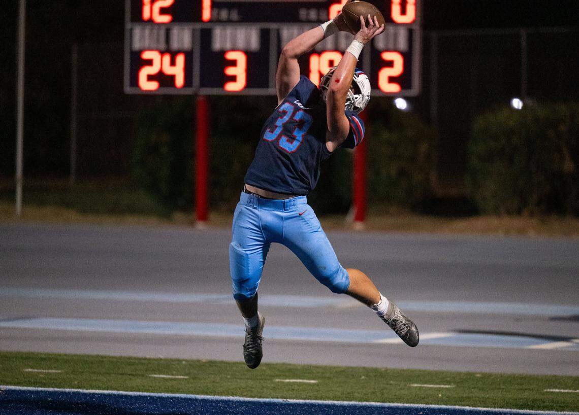The Destiny Christian Lions’ Andrew Axtell (33) catches a two-point conversion in the second quarter against the Linden Lions on Friday in Rosemont.