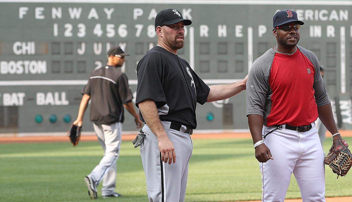 BOSTON, MA - JULY 16: Kevin Youkilis #20 of the Chicago White Sox talks with Jerry Royster #43, third base coach of the Boston Red Sox before their game at Fenway Park July 16, 2012 in Boston, Massachusetts. (Photo by Jim Rogash/Getty Images)