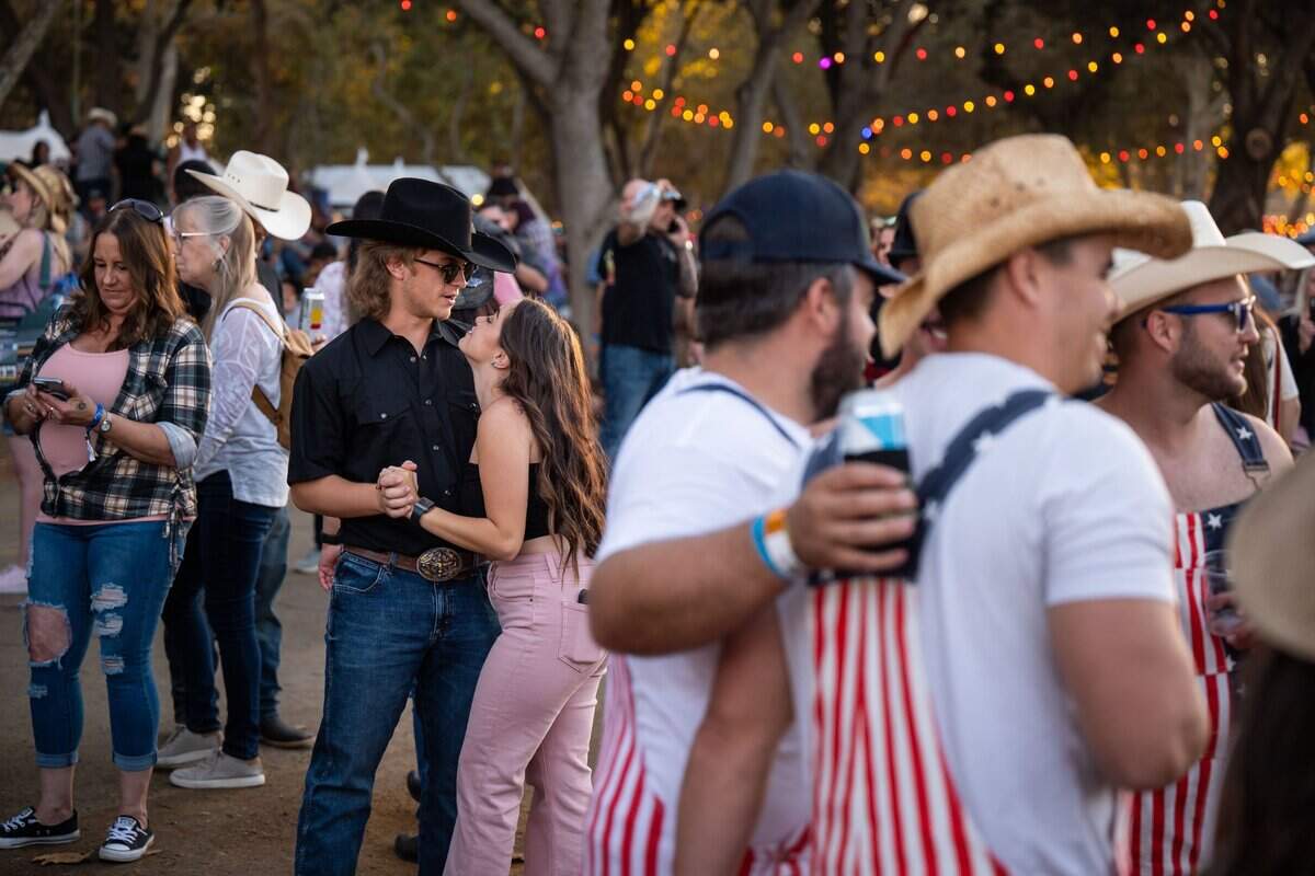 Katie Powers looks up at Timothy Davis, both of Oakdale, while dancing in Discovery Park at the GoldenSky country music festival Saturday, Oct. 15, 2022, in Sacramento. The two-day event featured headliners Tim McGraw and Sam Hunt, as well as Brothers Osborne, Midland, Carly Pearce and more.