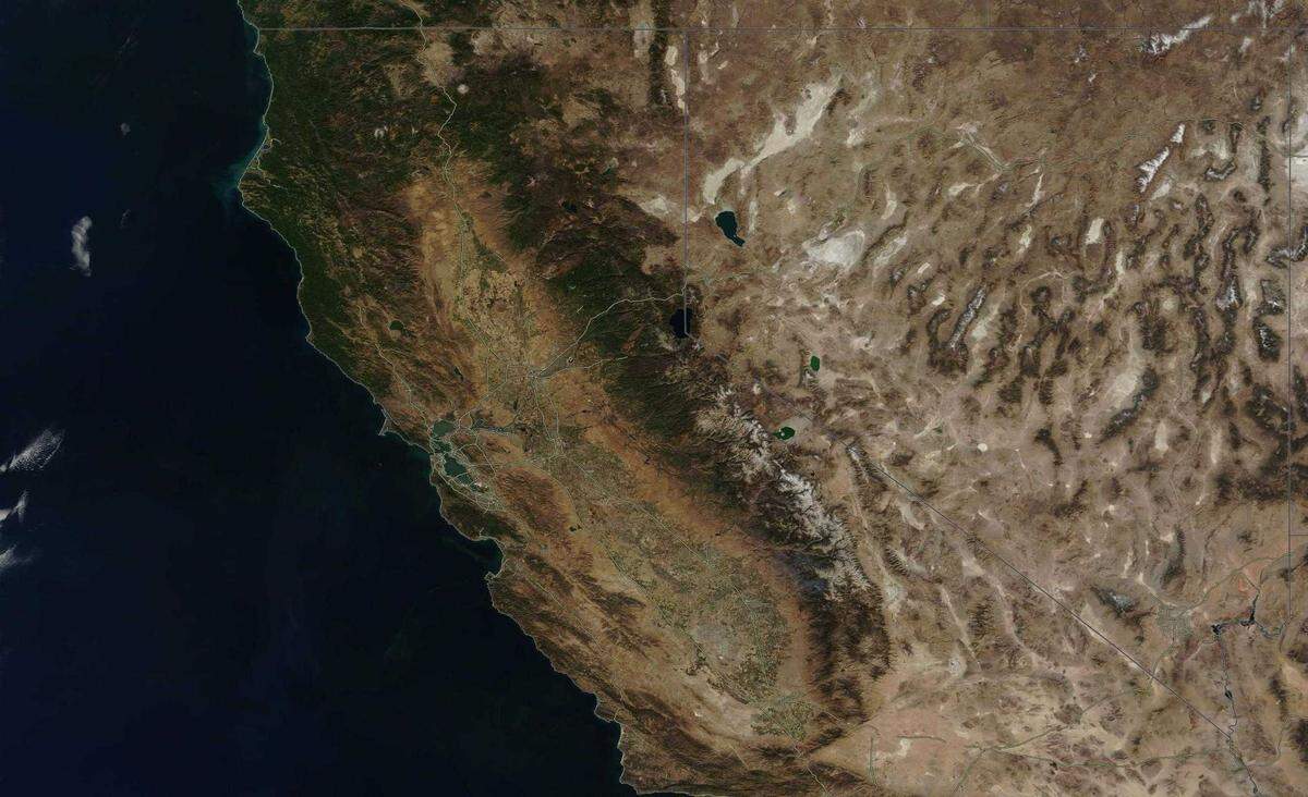 Northern California is seen Oct. 16, 2021, in a MODIS Corrected Reflectance satellite composite image produced by NASA’s Earth Observing System Data and Information System. A before-and-after view of the imagery shows the striking change to the Sierra Nevada following a historic storm that swept across Northern California over the week.