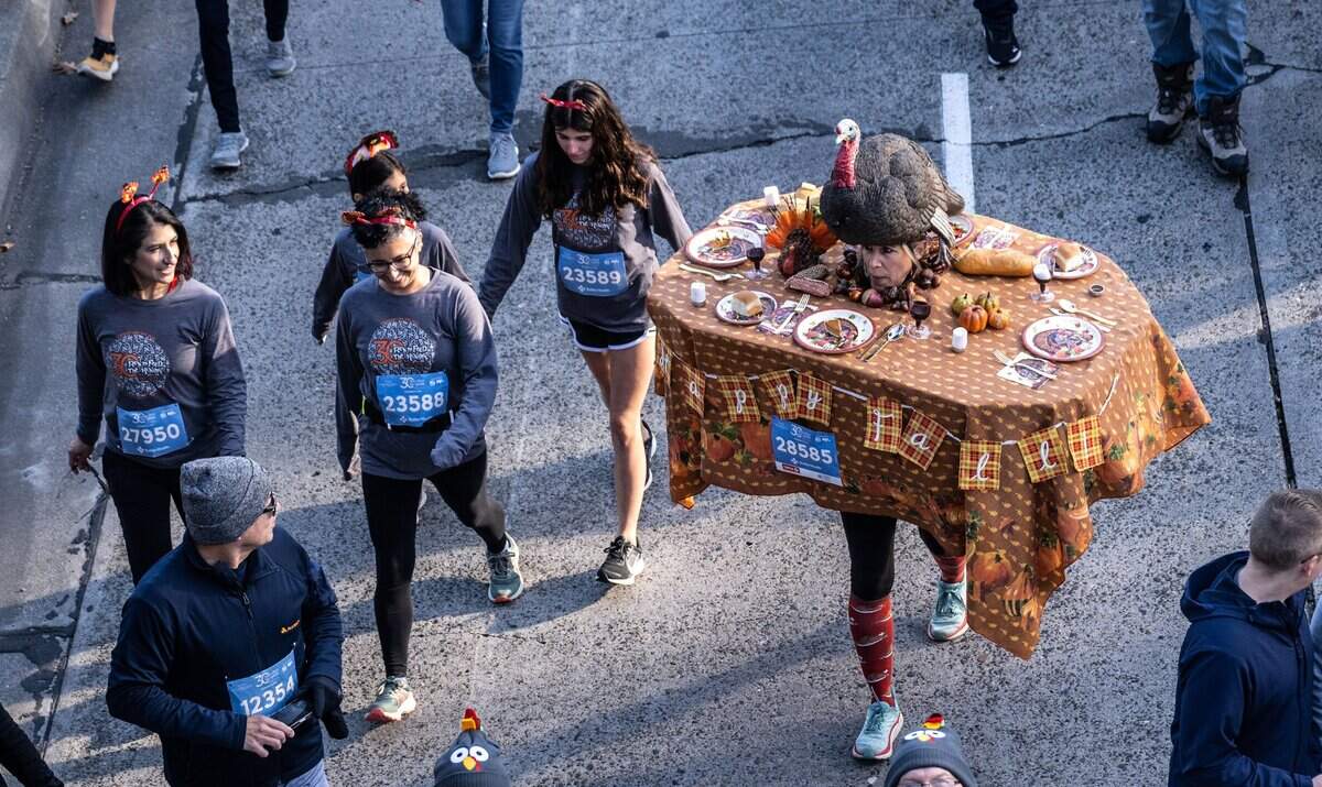 Sacramento resident Heather Oakes, dressed in a Thanksgiving dinner table costume, participates in the 30th Annual Run to Feed the Hungry on Thursday in East Sacramento.