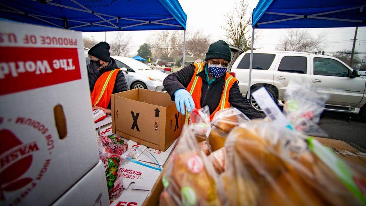 Volunteer Carolyn Hairston, of Elk Grove, readies boxes of food for volunteers to load into cars that are waiting at Hiram Johnson High School in January at one of the food distribution sites run by the Sacramento Food Bank.