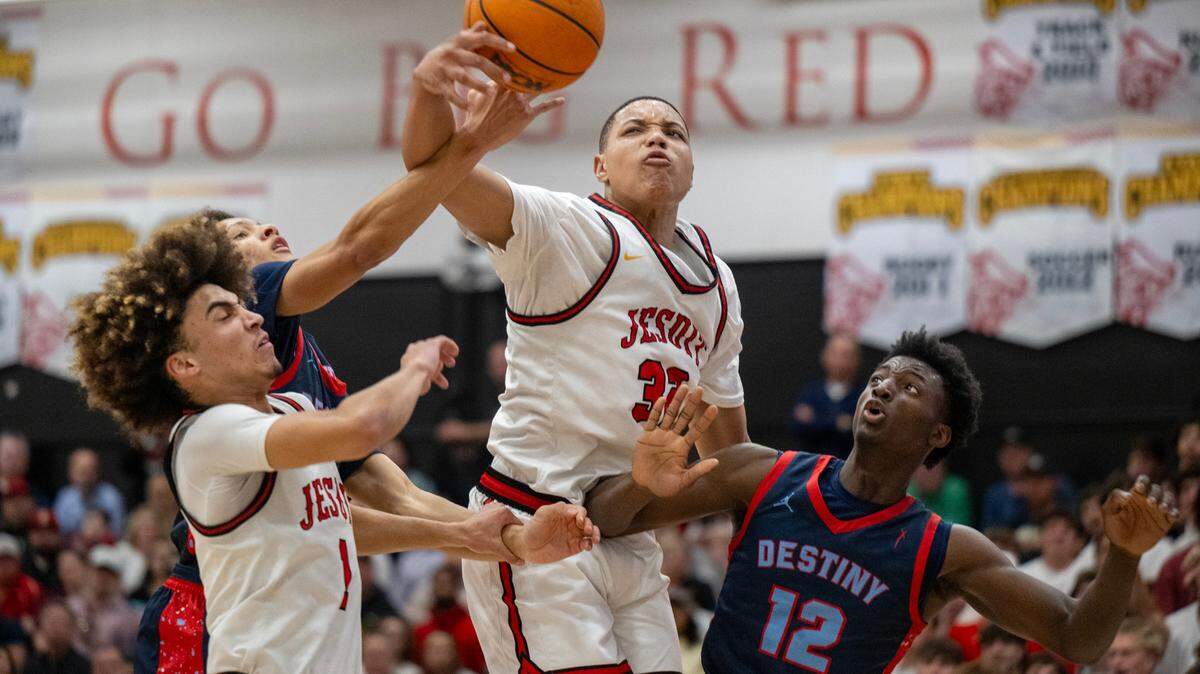 The Jesuit Marauders’ Amaury Mckinney (32) battles for a rebound with the Destiny Christian Lions’ Mohamed Kamara (12) in the CIF Northern California boys basketball championship game on Tuesday. 