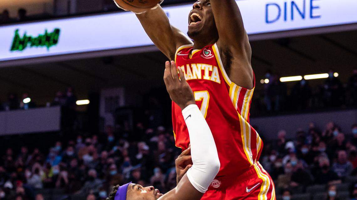 Atlanta Hawks forward Onyeka Okongwu (17), right, dunks with energy over Sacramento Kings guard Buddy Hield (24) during the fourth period of the NBA basketball game Wednesday, Jan. 5, 2022, at Golden 1 Center in Sacramento. The Hawks beat the Kings, 108-102.