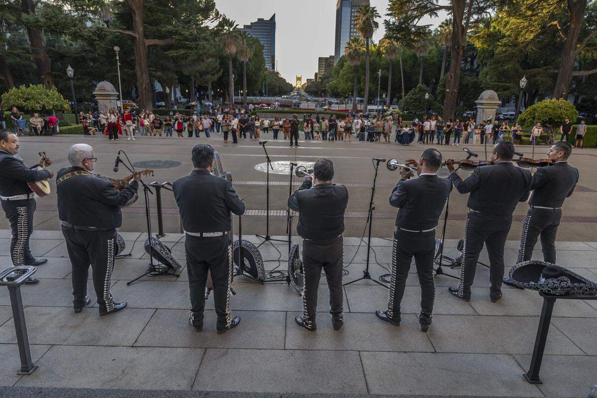 Mariachi Viva Jalisco entertains the crown on the west steps of the state Capitol on Monday, the eve of Mexican Independence Day. The event, which can normally count on attendance in the thousands, drew a few hundred people this year amid the federal crackdown on immigration. 
