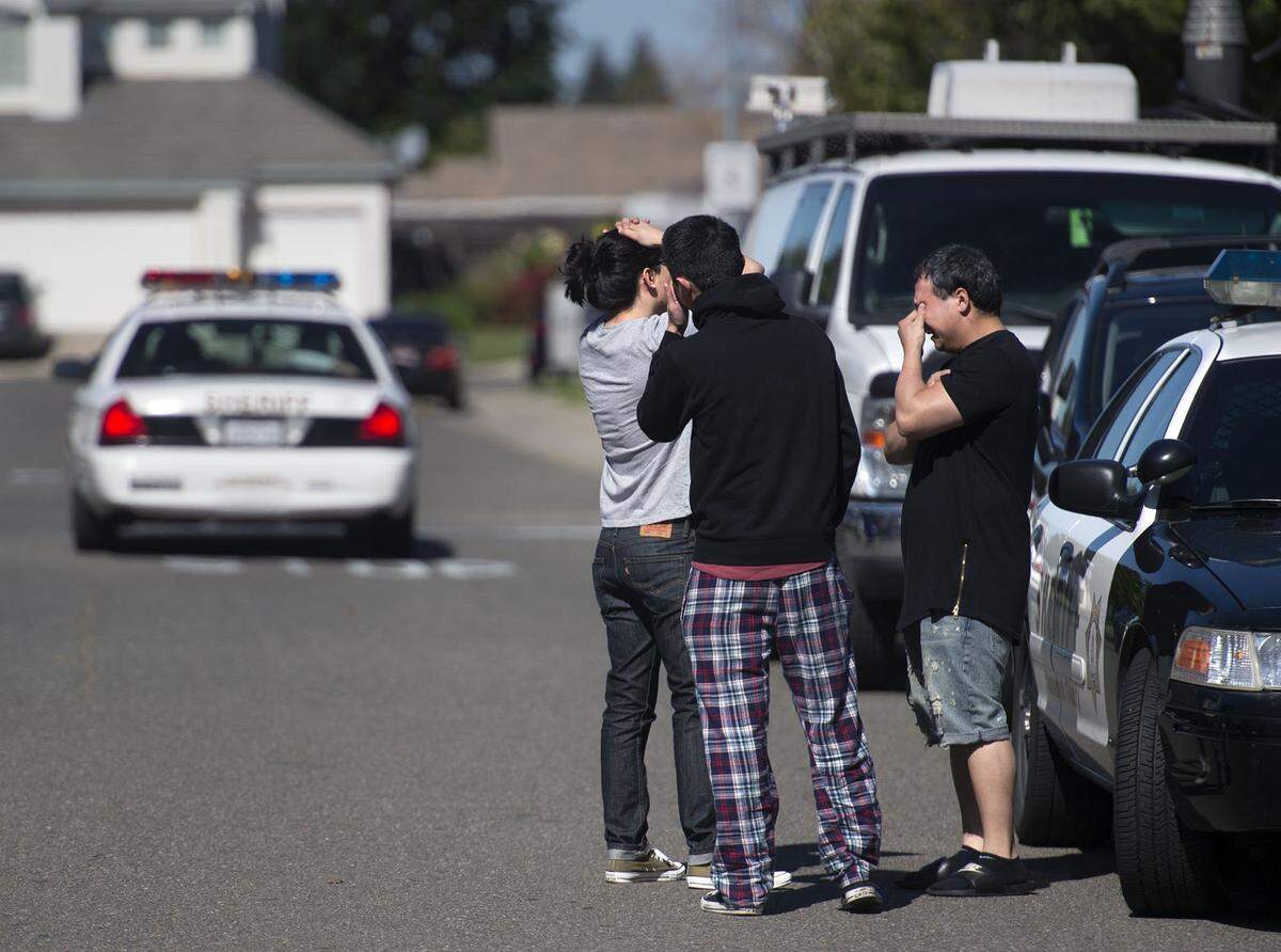 Three young men react after a triple shooting on Thursday, April 28, 2016 in Sacramento, Calif. Sheriff deputies were called to a house on Ardith Drive about 6:30 a.m., where three men were shot. All three men were declared dead at the scene. Sheriff’s spokesman Sgt. Tony Turnbull said there were others in the home at the time of the shooting and they are uninjured.