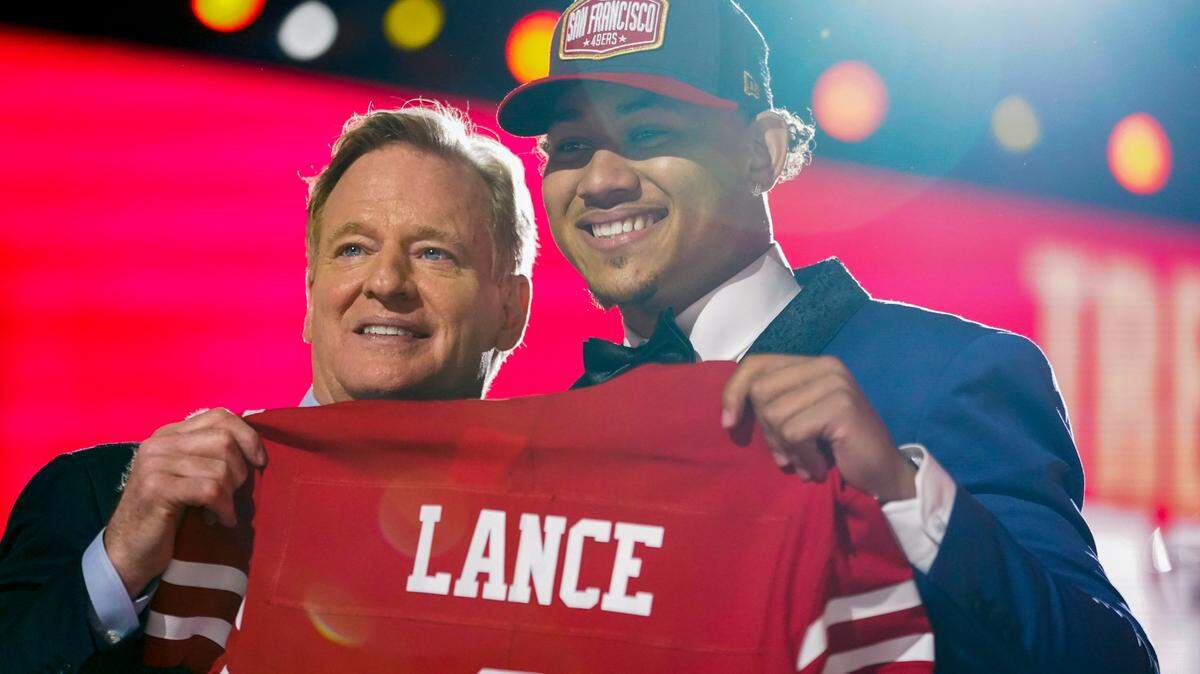 North Dakota State quarterback Trey Lance holds a 49ers jersey with NFL Commissioner Roger Goodell after being chosen by San Francisco with the third pick Thursday April 29, 2021, in Cleveland.