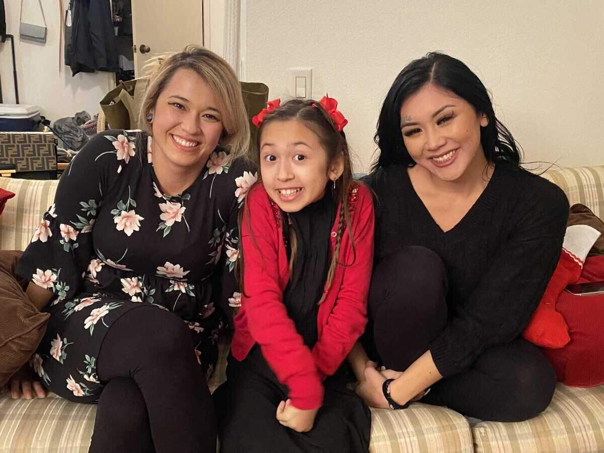 Angelica Bravo, right, is seen in a Christmas photo last year with her sisters, Cecilia Spencer, left, and Lumina Bodea. Bravo was found unresponsive July 8, 2024, in a home on Didcot Circle, where she was pronounced dead. Her family is seeking answers more than a week after her two youngest children disappeared with their father, Camron Lee.