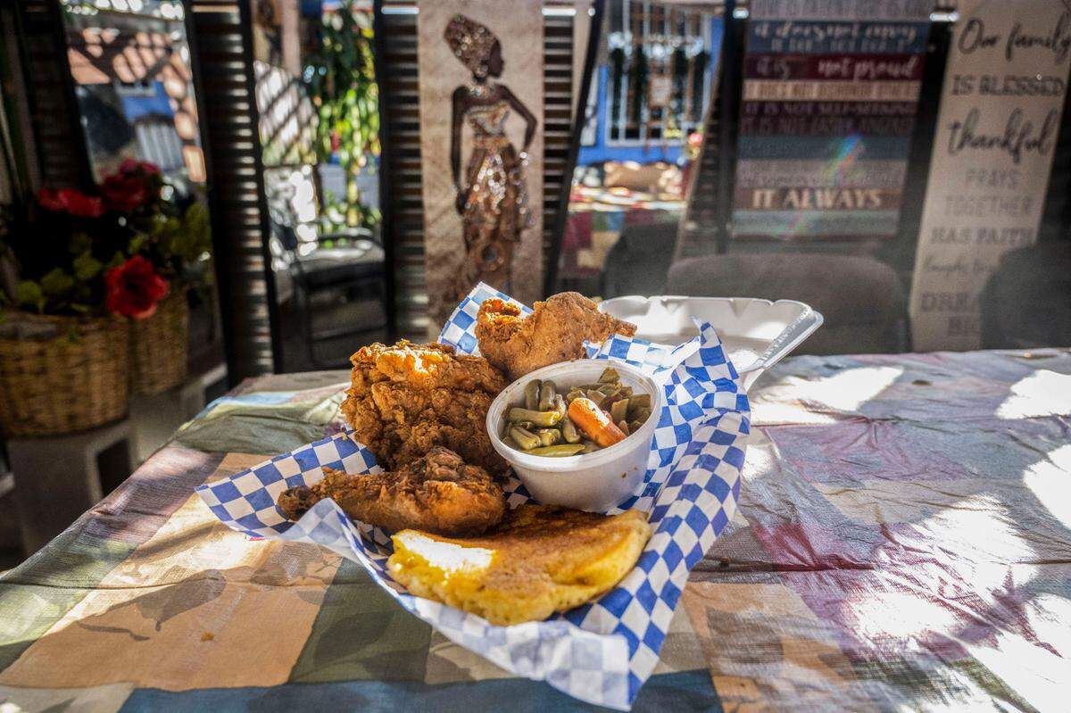 A fried chicken combo at Tori’s Place sits ready to eat on Wednesday, Nov. 9, 2022. It includes three pieces of chicken, corn bread and green beans.