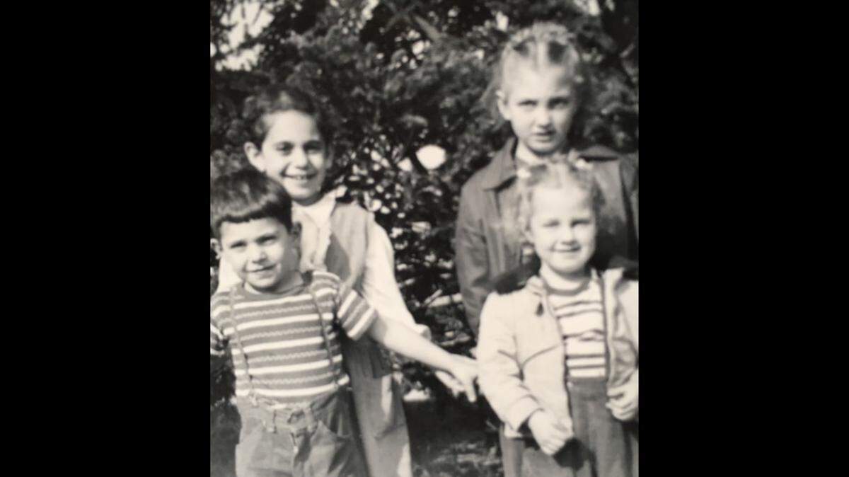 Pauline Sahakian with her younger brother, Robert Keurejian, left, and Pam Jones with her little sister, Nancy, right, standing in front of the pine tree in the Keurejian’s front yard. The photo was taken by Pauline’s maternal grandfather, Nazareth Tateosian, circa 1952-53.