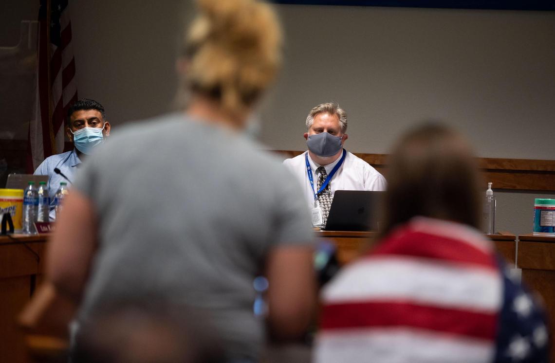 Jennifer Lane speaks alongside her 9-year-old daughter — one of three children she said she will be pulling from the Natomas Unified School District — directly addressing district Superintendent Chris Evans, center, during a meeting Wednesday, Sept.1, 2021, at the district headquarters in Natomas. An Inderkum High School AP Government teacher was shown in a video released by Project Veritas, a conservative activist group that often produces undercover videos, discussing antifa and saying he wanted his students to become “revolutionaries.”