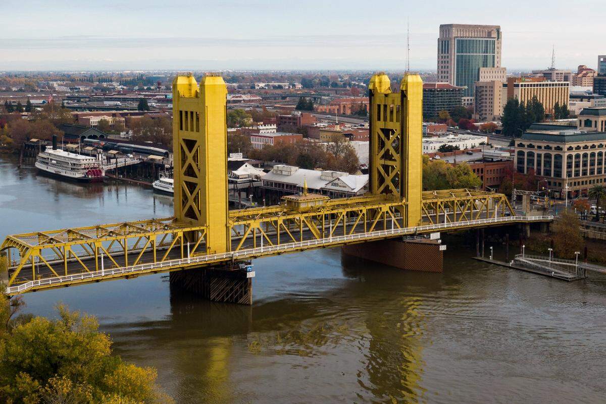 The Tower Bridge, connecting Sacramento to West Sacramento, from a drone overlooking downtown Sacramento and the Sacramento River.