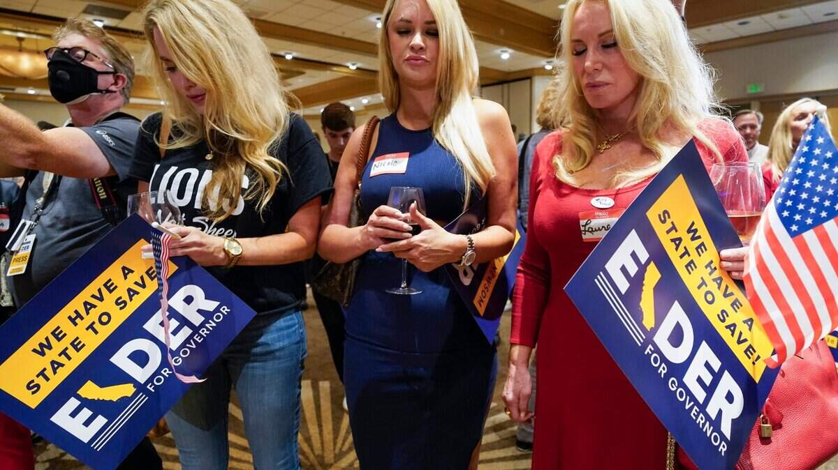 Supporters of Republican conservative radio show host Larry Elder pray as polls close for the California gubernatorial recall election Tuesday, Sept. 14, 2021, in Costa Mesa, Calif. The rare, late-summer election, which challenged California Gov. Gavin Newsom, has emerged as a national battlefront on issues from COVID-19 restrictions to climate change. (AP Photo/Ashley Landis)