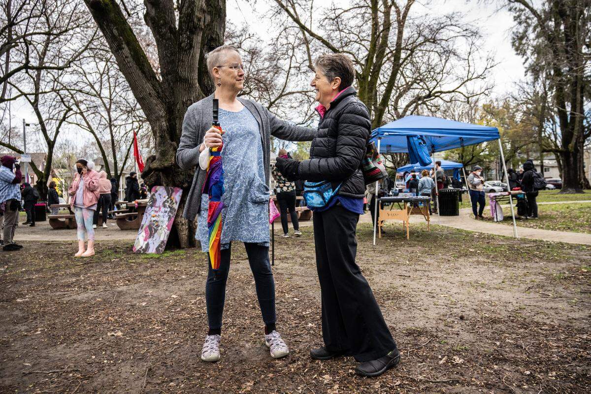 Lisa Bunker and wife Dawn Huebner attend a Support Trans Youth event in Southside Park on Friday that was held in opposition to the Detransition Awareness Day event scheduled later in the day at the state Capitol.