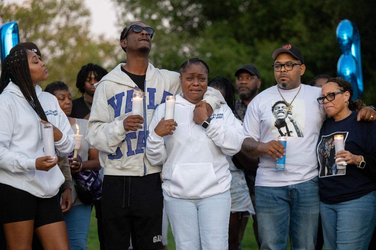 Shelly Tevis, center, grieves for her son Colby Tevis with family members and friends during a vigil at Burberry Community Park in Sacrmaento. Colby Tevis was killed and another hospitalized after a shooting early Saturday morning on J Street in midtown Sacramento.