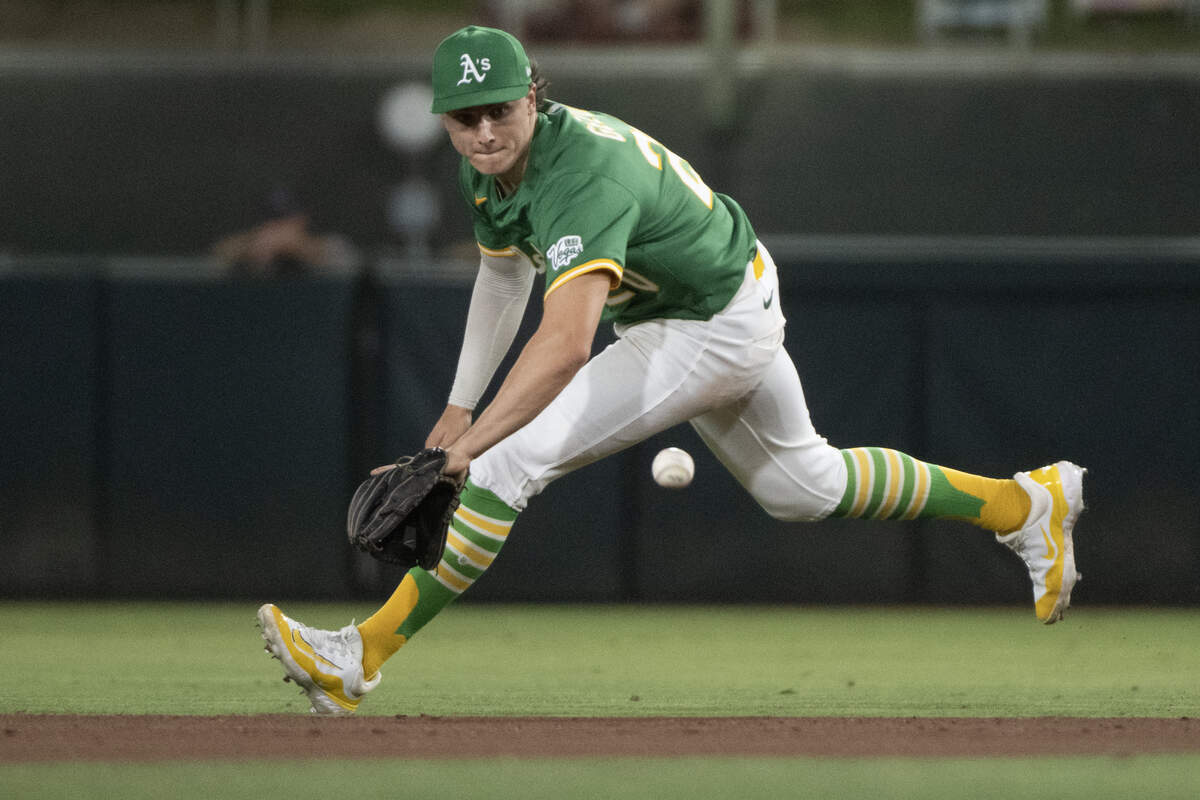Athletics infielder Zack Gelof tries to field a ball hit by Texas Rangers first base Rowdy Tellez in the seventh inning during a game at Sutter Health Park on Friday, Aug. 29, 2025, in West Sacramento. Gelof has played well since being recalled earlier this season and will look to compete for a starting job when two infield starters return.