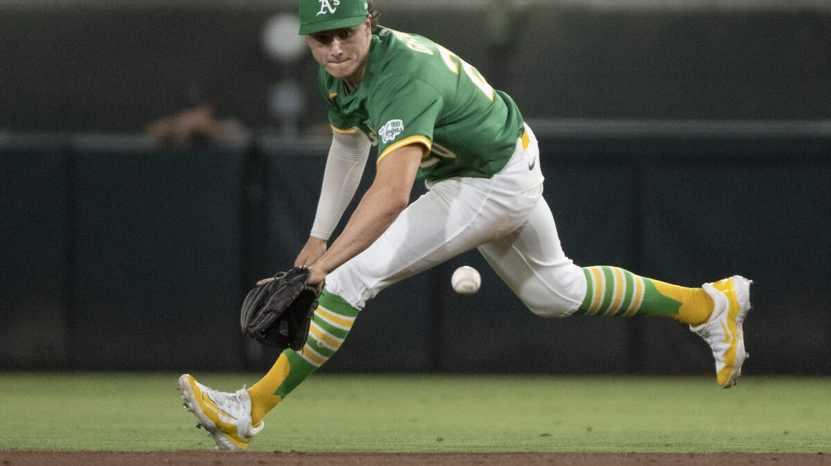 Athletics second baseman Zack Gelof tries to field a ball hit by Texas Rangers first baseman Rowdy Tellez in the seventh inning during a game at Sutter Health Park on Aug. 29, 2025, in West Sacramento. Gelof was placed on the injured list for the second time this season on Friday.