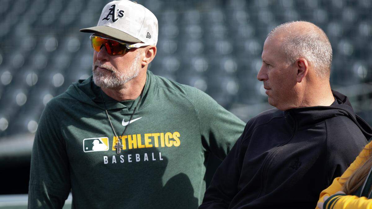 May 16, 2025; San Francisco, California, USA; Athletics manager Mark Kotsay (left) chats up team general manager David Forst before their game against the San Francisco Giants at Oracle Park. Mandatory Credit: D. Ross Cameron-Imagn Images
