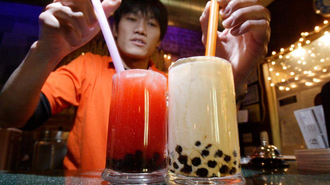 Jim He, of the Green Tea Cafe serves up glasses of bubble tea on Mott Street in the Chinatown neighborhood of New York in 2005. A global shipping snarl has delayed deliveries of tapioca, necessary to brew boba tea, leaving bubble tea lovers distraught.