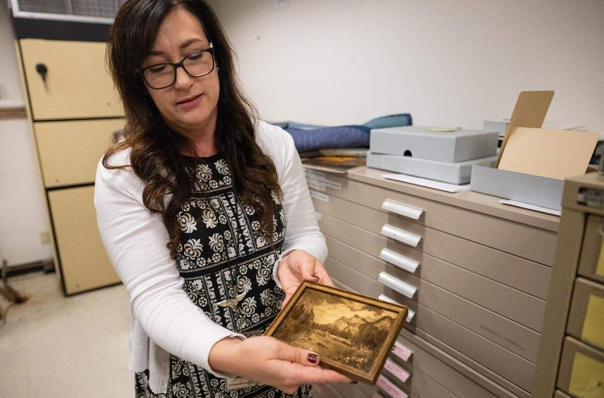 Jessica Knox-Jensen, bureau chief at the California State Library in Sacramento, presents an orotone photograph of the Yosemite Valley – one of her favorite items in their collection – in the library’s climate-controlled vault on Thursday.