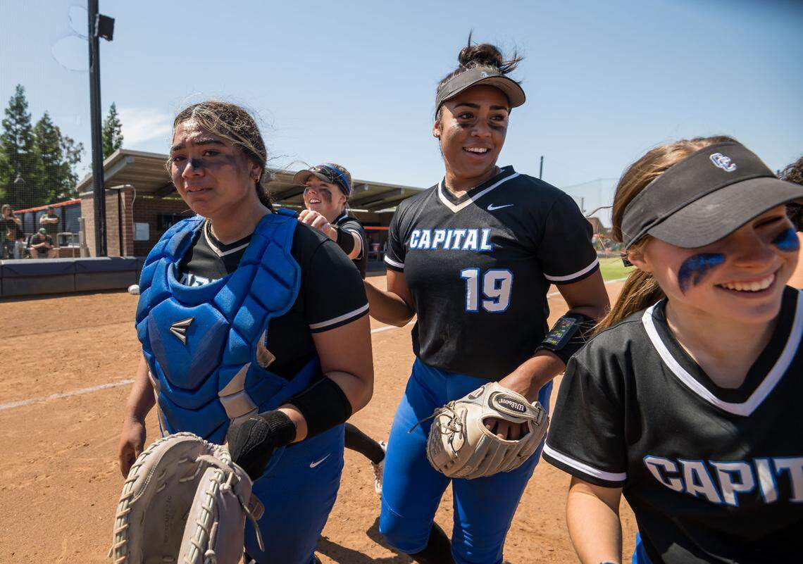Capital Christian Cougars catcher Nani Lose-Mahina (21), left, pitcher Ayla Tuua (19) and teammates walk off the field after their win over the Dixon Rams at the CIF Sac-Joaquin Section Division IV high school softball championship game Saturday, May 27, 2023, at Cosumnes River College. Capital Christian is now Destiny Christian Academy.