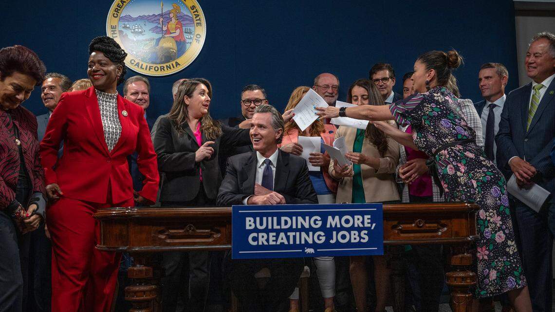 California Gov. Gavin Newsom tucks his pen away Monday after signing the infrastructure streamlining bill package that will accelerate critical projects.