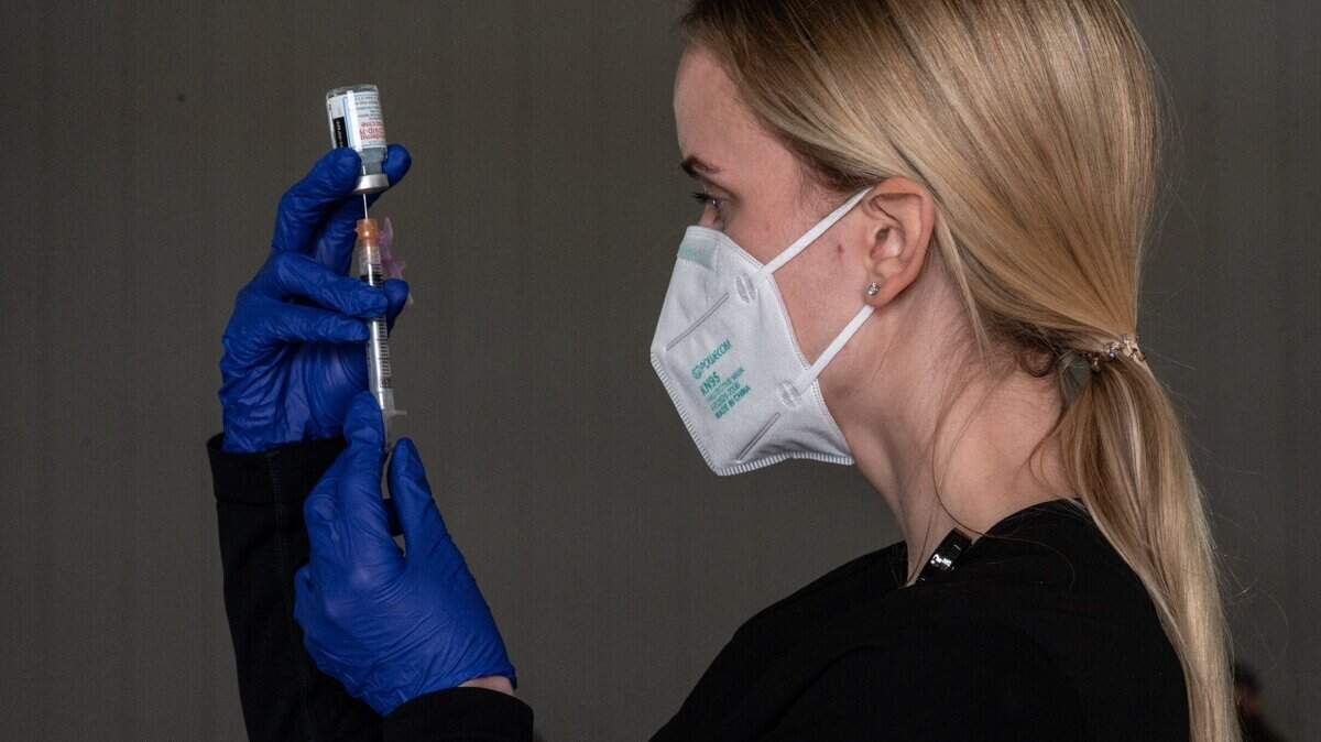 Nurse Katherine Ambrose, of the Sacramento Medical Reserve Corps, prepares a COVID-19 Moderna vaccine at a drive-thru Sacramento County Public Health clinic at Cal Expo on Thursday, Jan. 21, 2021. 