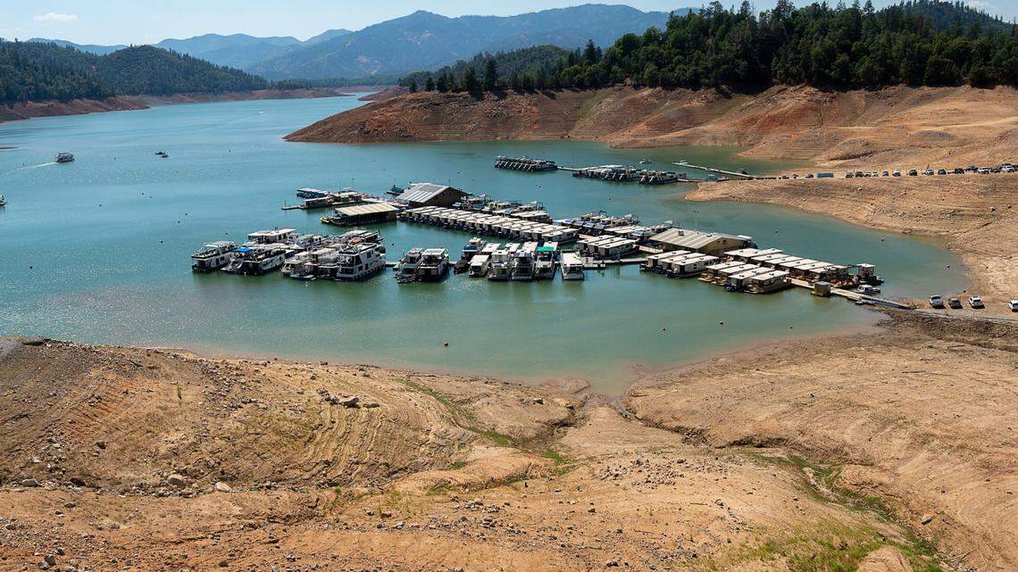 Low water levels expose the bottom of Lake Shasta as boats and docks float in the water near the Bridge Bay Resort on Wednesday, June 30, 2021 in Shasta County. California was one of five states experiencing the hottest summer ever, joining Nevada, Idaho, Oregon and Utah.