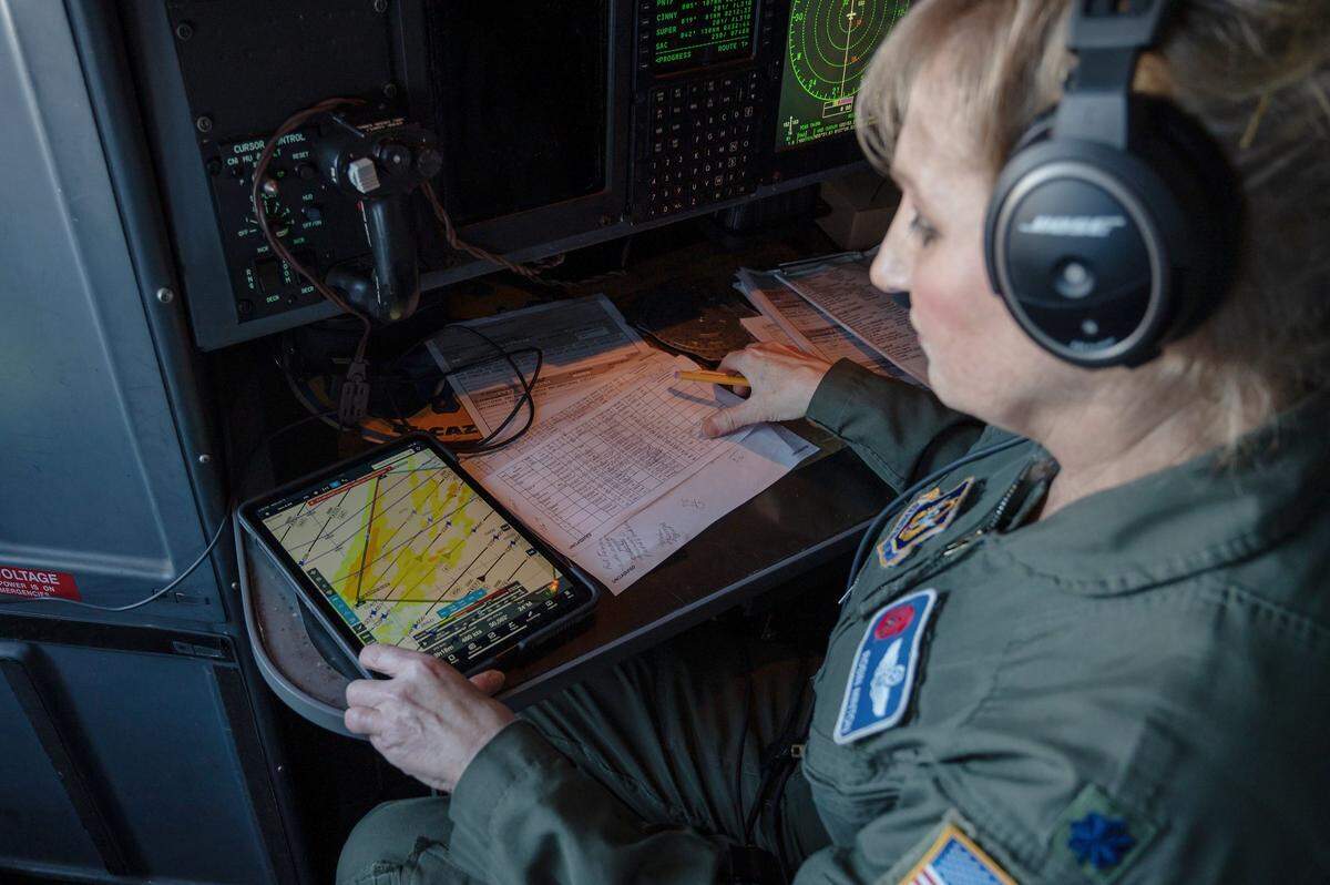 Lt. Col. Robin Minton, navigator for the “Hurricane Hunters”, looks at the chart showing the flight path over the Pacific Ocean on Wednesday.