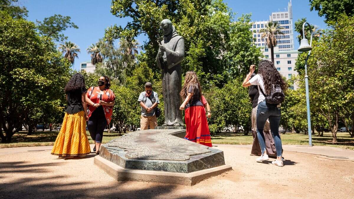 People meet outside the California Capitol on Tuesday, June 16, 2020, to advocate for the removal of the Capitol Rotunda’s sculpture of explorer Christopher Columbus with Queen Isabella. Since the Capitol was closed, advocates gathered near the Junipero Serra statue on Capitol grounds.