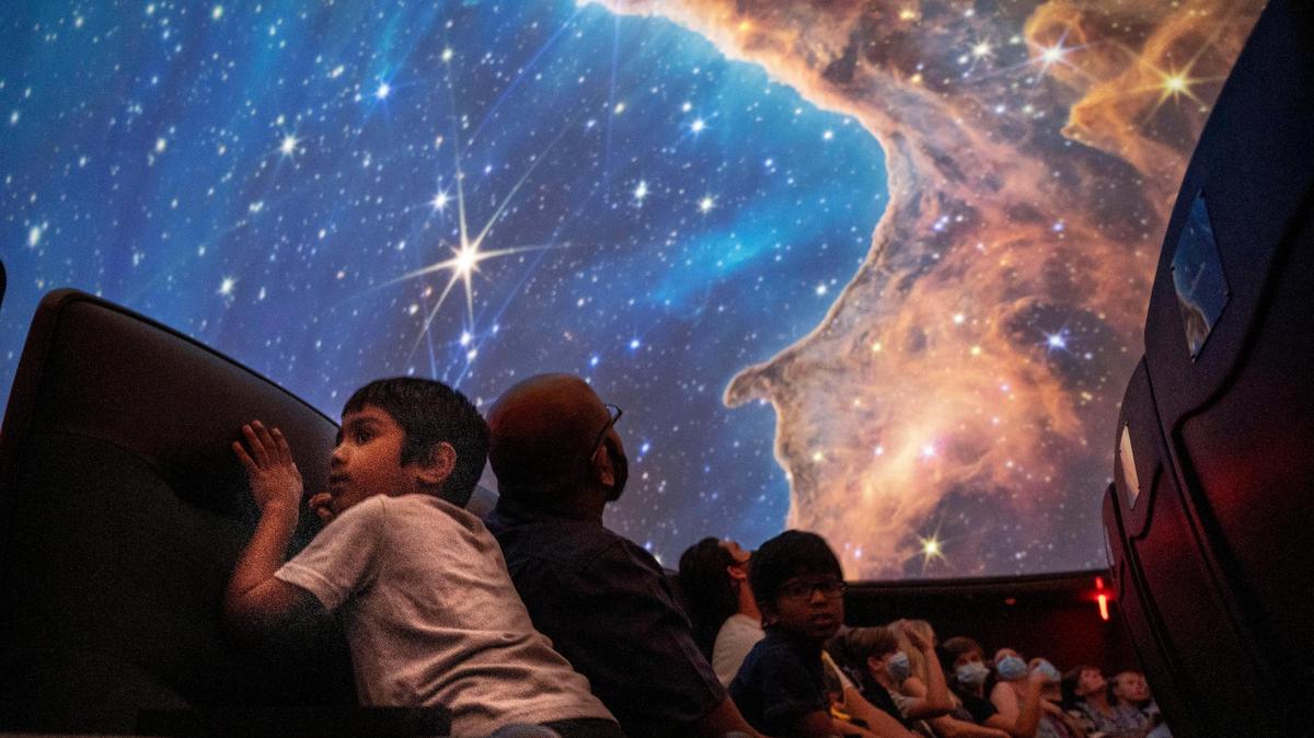Arjon Balakrishnan, 5, of Rocklin looks at an image of the Carina Nebula at the Sacramento State Planetarium, which partnered with NASA to show the first images captured by the new James Webb Space Telescope.