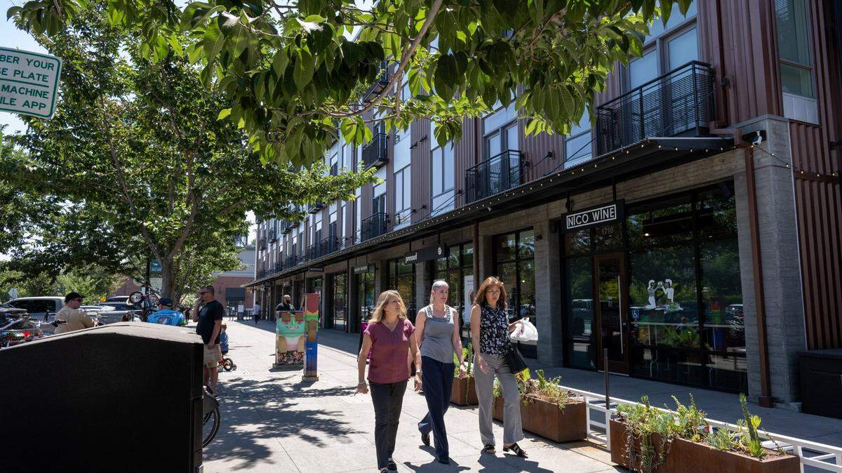 People walk down R Street on July 19, 2023. It took decades to develop, but the R Street corridor in Sacramento has not only become a flourishing transit-oriented neighborhood. It is arguably the region’s most successful urban development landscape.