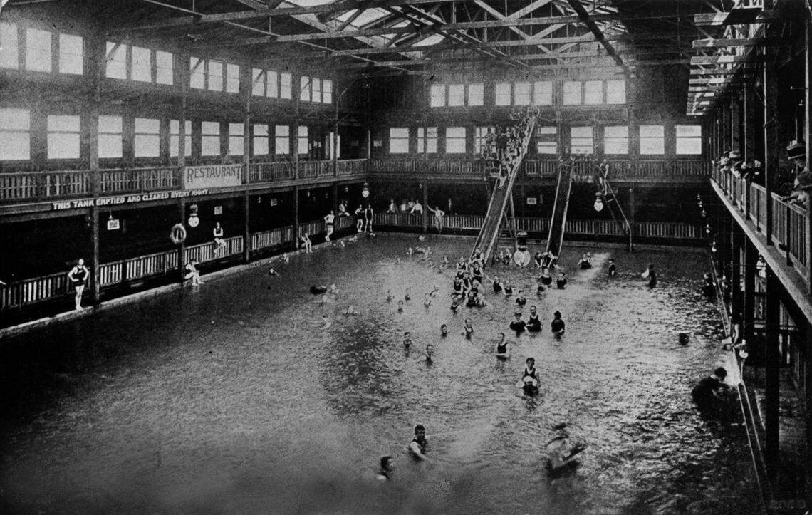 Swimmers cluster around the water slides at the Riverside Baths. The 100-yard indoor pool opened in 1909, before the creation of William Land Park across the street and the area's annexation by the city of Sacramento. It was converted to an outdoor facility in 1937. 