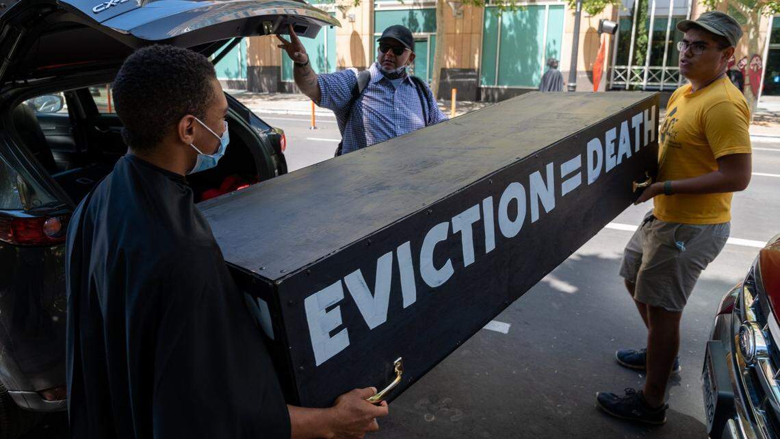 Tenants and advocates carry a casket to protest in front of the California Apartment Associations (CAA) headquarters in Sacramento on Friday, June 25, 2021. Gavin Newsom and state lawmakers struck a deal Friday to extend California’s eviction moratorium until end of September and rent relief program amid COVID pandemic.