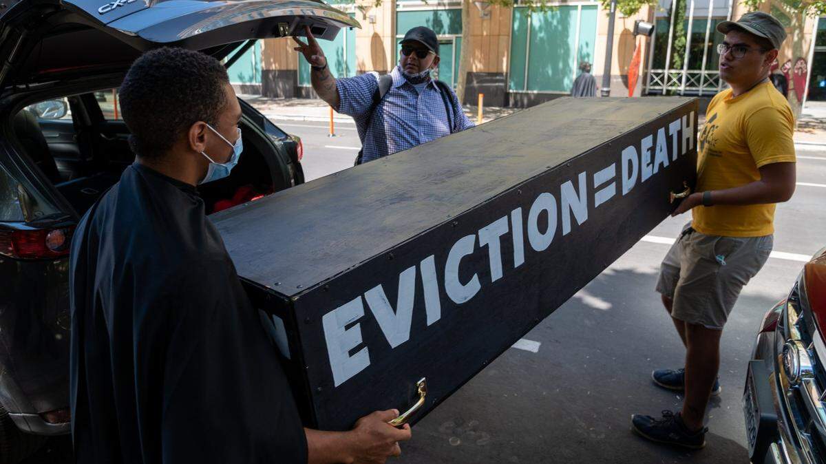Tenants and advocates carry a casket to protest in front of the California Apartment Associations (CAA) headquarters in Sacramento on Friday, June 25, 2021. Gavin Newsom and state lawmakers struck a deal Friday to extend California’s eviction moratorium until end of September and rent relief program amid COVID pandemic.