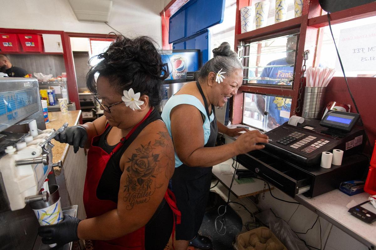 Leilan Kitchens makes milkshakes as her mother Joann Kahue rings up a sale at Lou’s Burgers on Oct. 20 in North Highlands. Leilan and Robert Kitchens have owned Lou’s for 14 years, and bought it from Robert’s grandfather, who owned it for 30 years. 