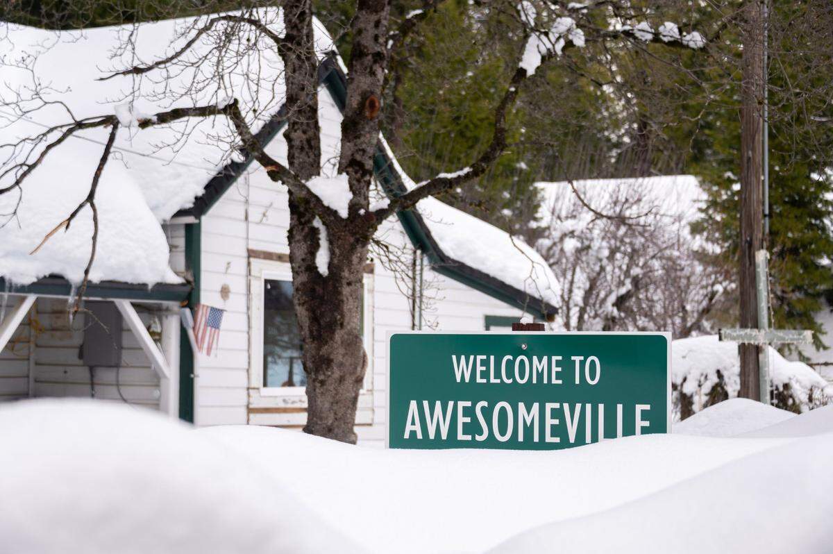 A sign in a yard in Alta that says “Welcome to Awesomeville” barely clears the snow pack on Tuesday.