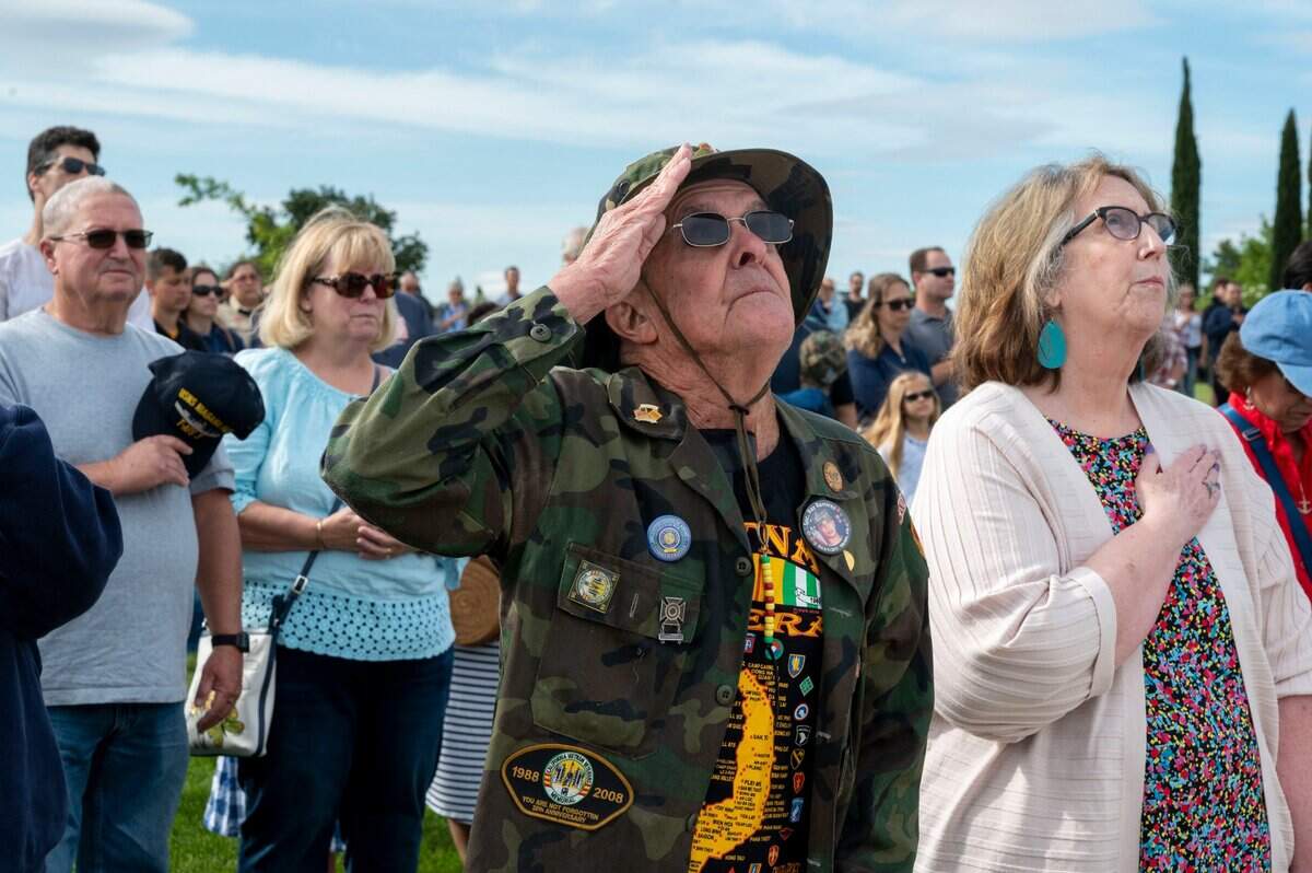 Vietnam Veteran Stan Bollinger, 77, of Roseville, salutes the flag as attendees stand for the National Anthem during a Memorial Day ceremony at the Sacramento Valley National Cemetery in Dixon on Saturday.