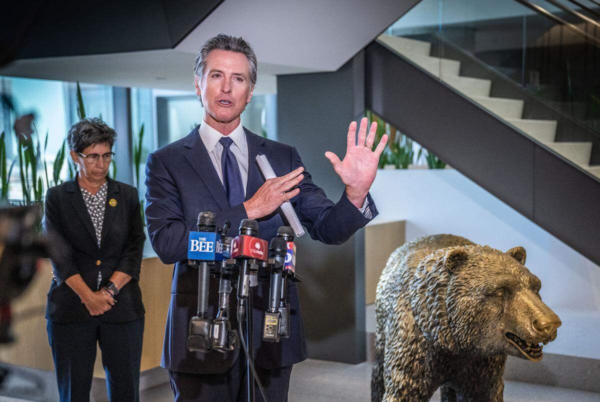 Gov. Gavin Newsom talks to members of the press during a press conference at his swing space office after meeting a coalition of behavioral health reform leaders and local elected officials on Wednesday, July 12, 2023.