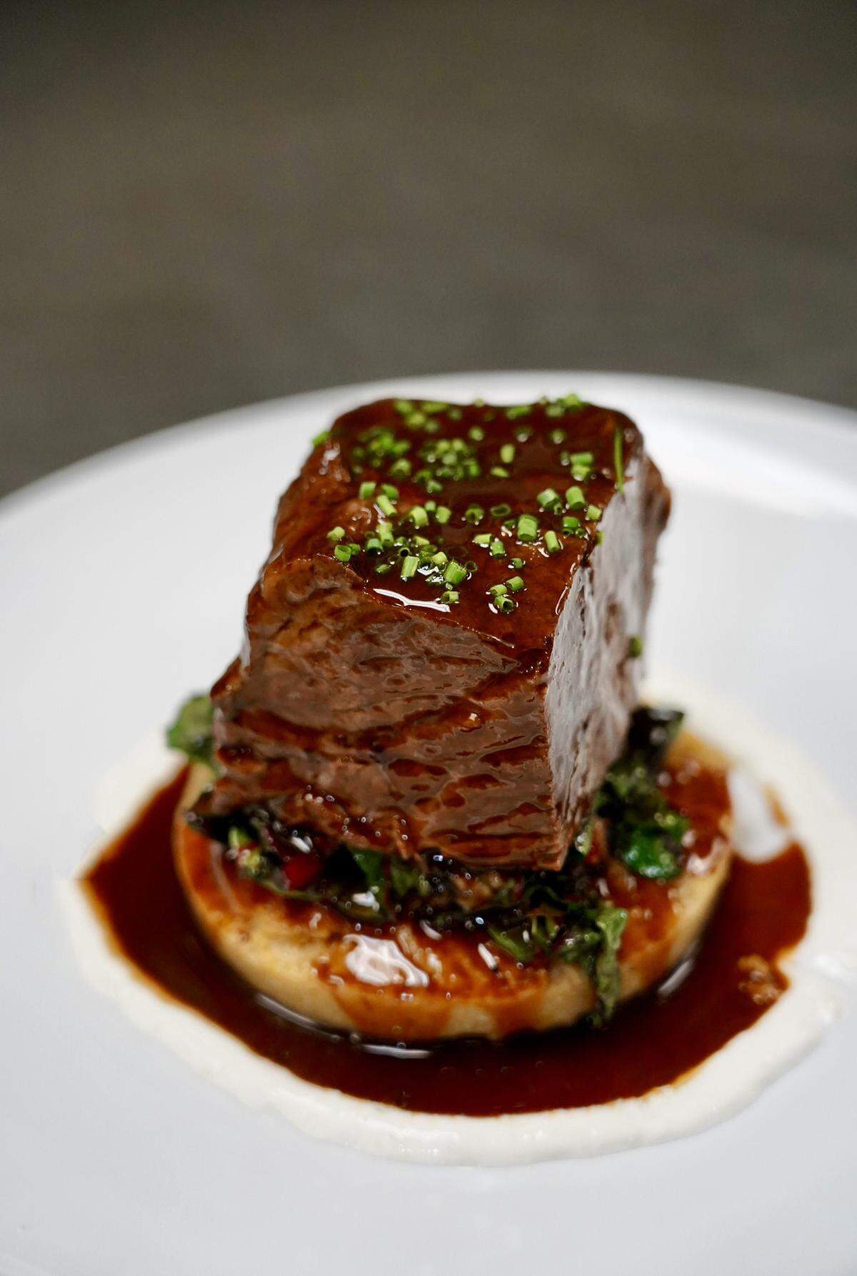 Butcher and Barrel’s short ribs on top of parmesan polenta, swiss chard and horseradish cream. 