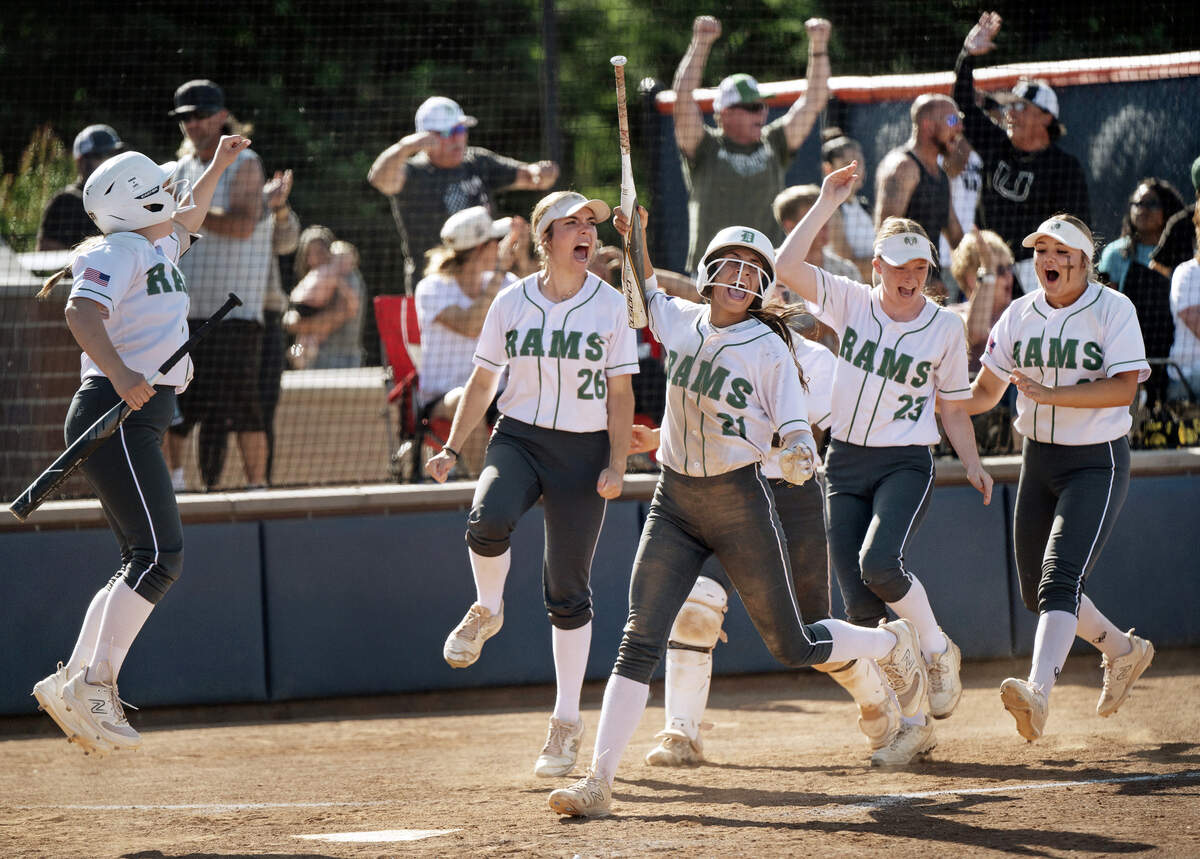 Dixon players celebrate a home run by Caitlyn Hendershot during the Sac-Joaquin Section Division IV softball championship game against Central Catholic on Saturday at Cosumnes River College. Dixon won the game 7-6.